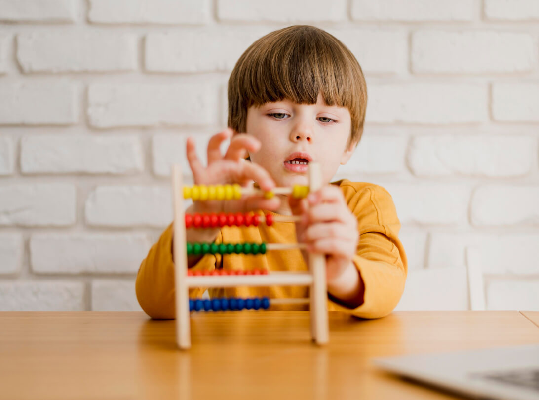 Child learning early maths with an abacus