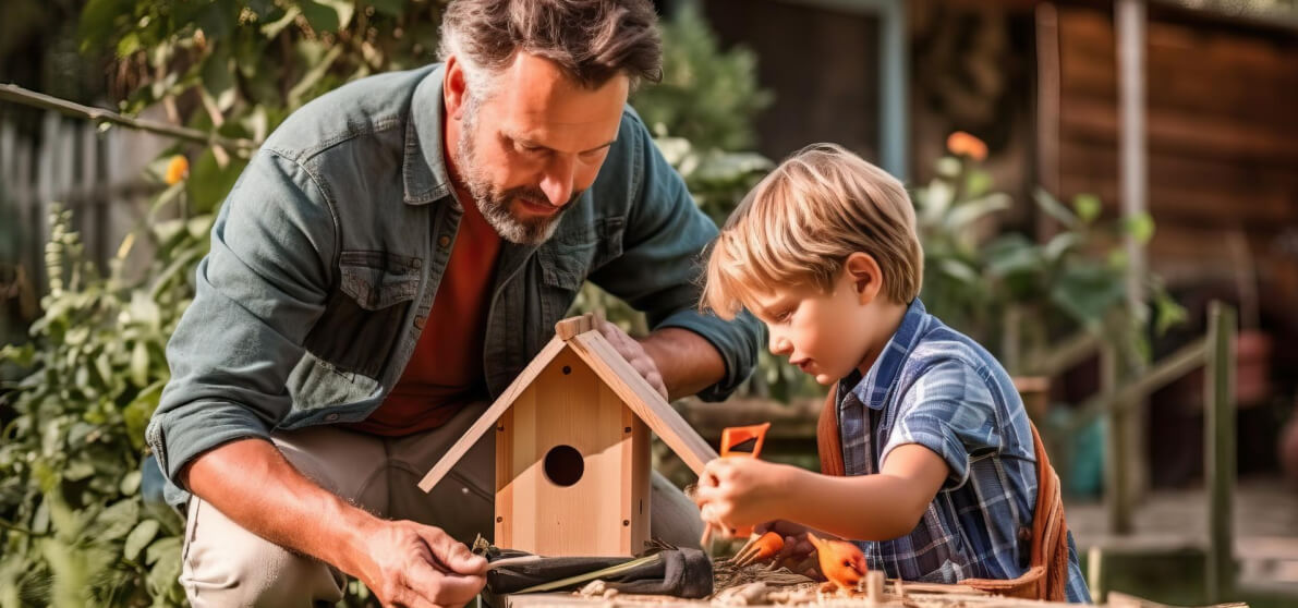 Parent and child building a birdhouse together